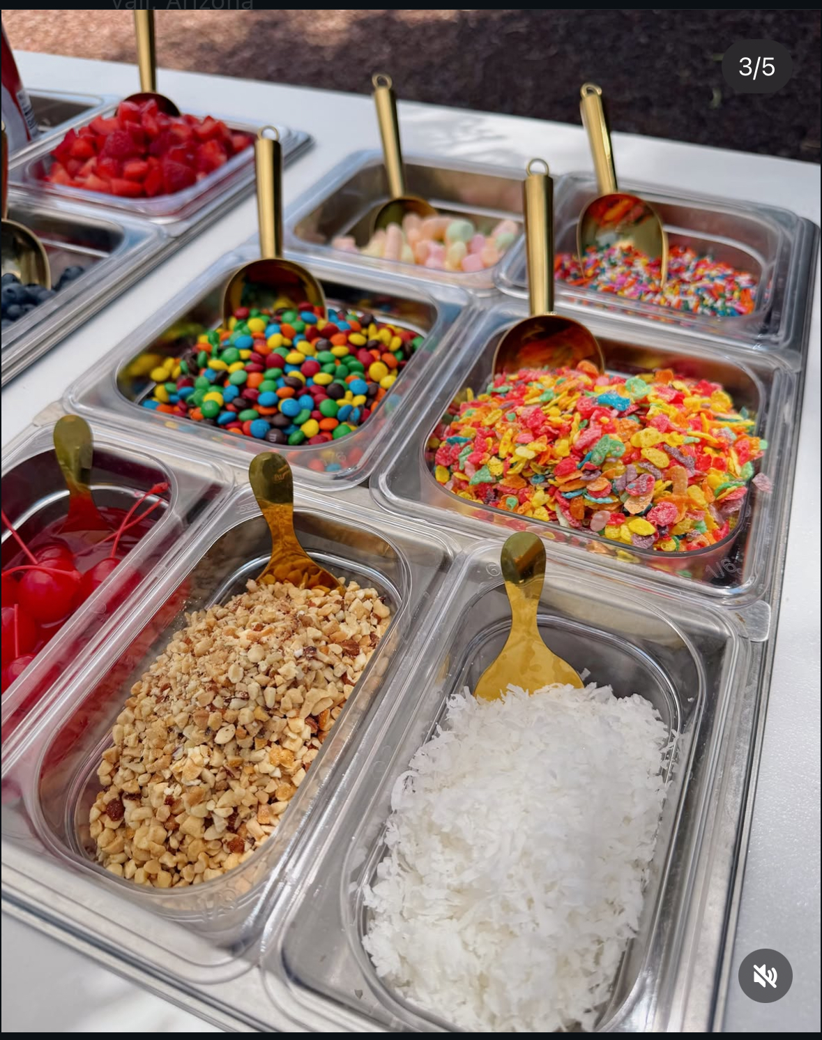 Toppings bar with gold scoops, fruit, candy and cereal
