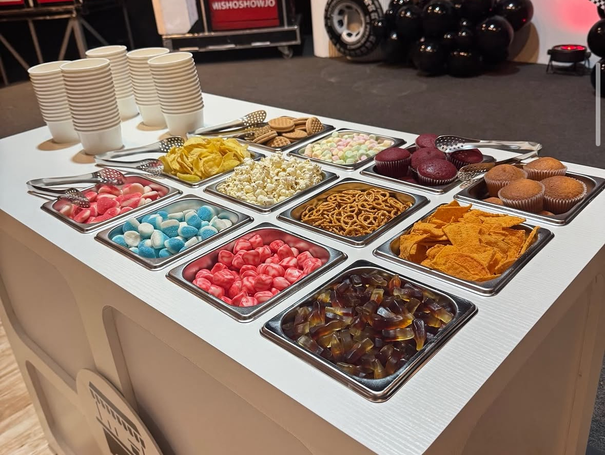 Snack and candy station with assorted treats and cups